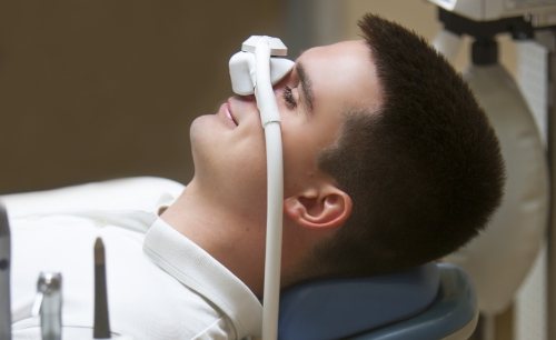 Relaxing dental patient receiving comfortable dental services with sedation dentistry