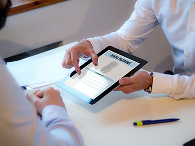 An insurance agent showing a dental insurance form to a patient