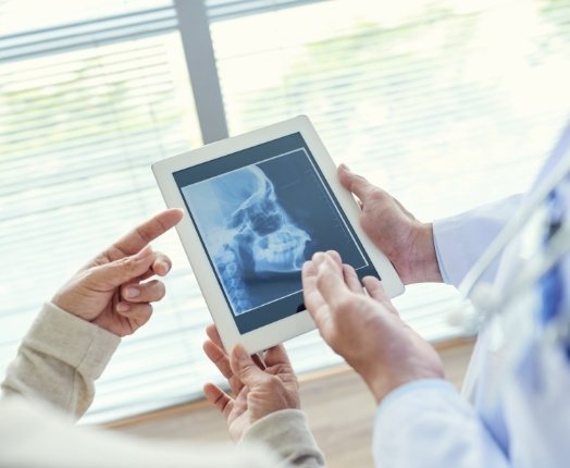 Dentists looking at x-rays during preventive dentistry checkup and teeth cleaning visit