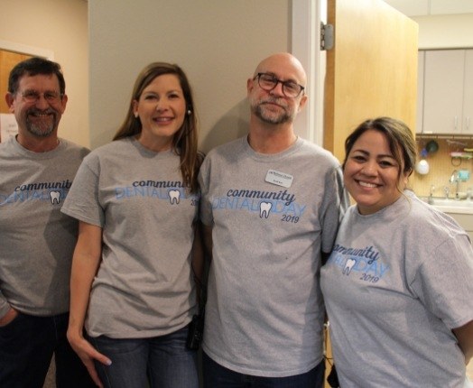 Four dental team members at community event