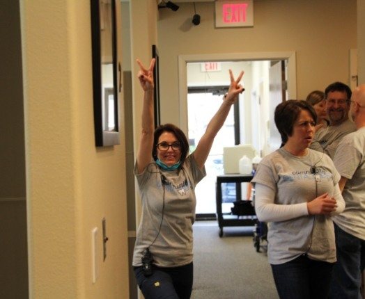 Group of dental team members in dental office hallway