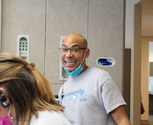 Two dental team members smiling during community event