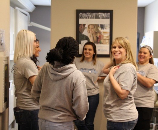 Group of team members laughing together while volunteering