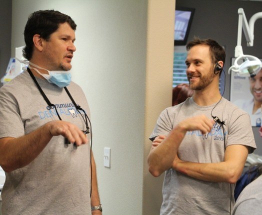 Two dental team members talking during community event