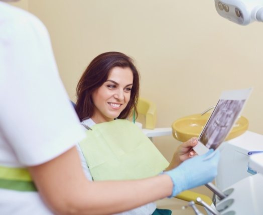 Dentist and dental patient discussing the cost of dental implants