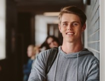 Young man with healthy smile after Invisalign orthodontics