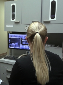 Dental team member looking at digital dental x rays