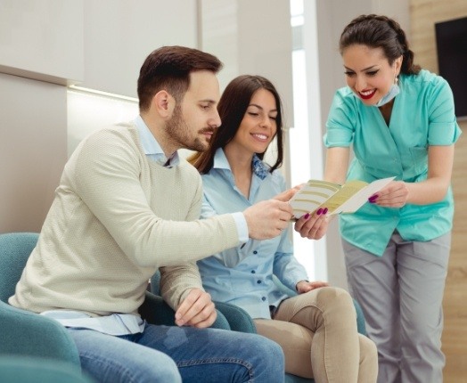 Dental team member explaining how dental insurance works