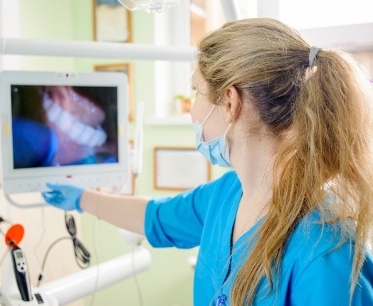 Dentist looking at images captured by intraoral camera