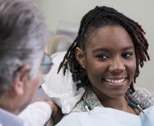 Dentist talking to dental patient