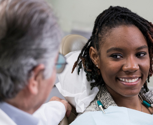 Woman listening to her dentist talk 