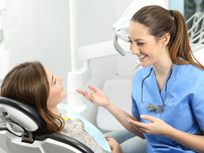 A dentist explaining dental implant treatment to her patient