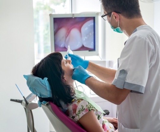 Dentist using intraoral camera to capture smile photos