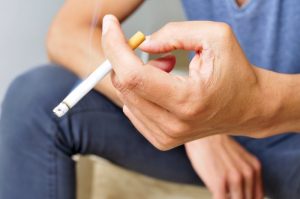 man holding cigarette in his hand