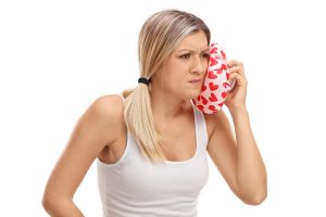 woman holding ice pack to jaw