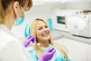 woman smiling sitting in dentist chair