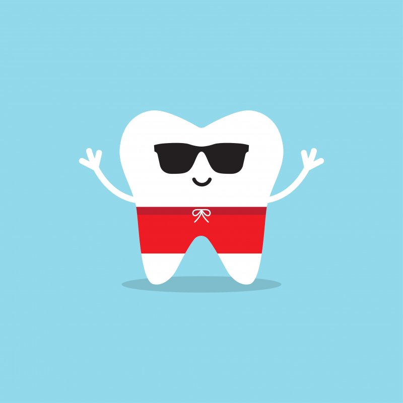 Happy healthy tooth in sunglasses and swim trunks