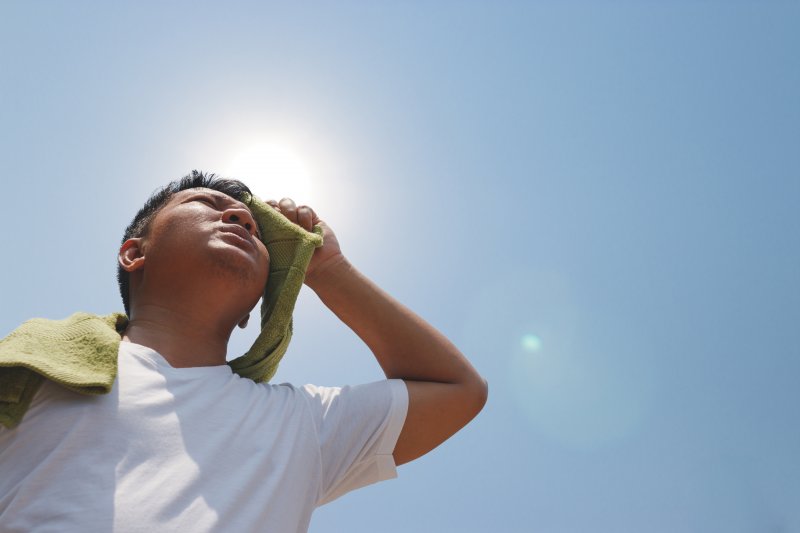 A man facing the signs of dehydration outdoors