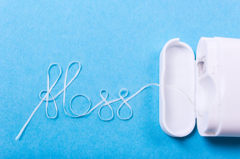 Dental floss spelling the word ‘floss’